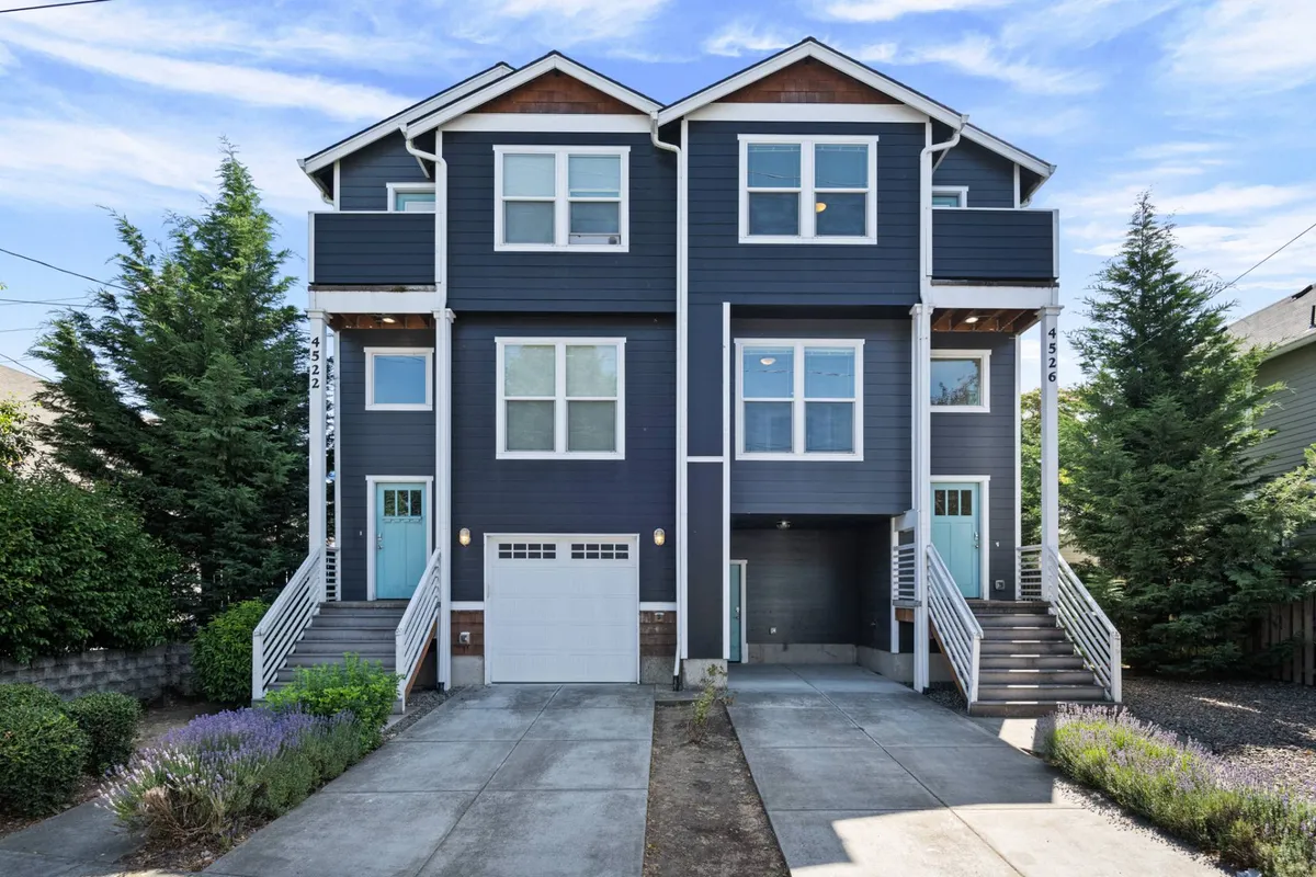 A welcoming exterior shot of the property, showcasing the modern architecture, double entry doors, and a landscaped front yard. The scene hints at both relaxation and community gatherings.