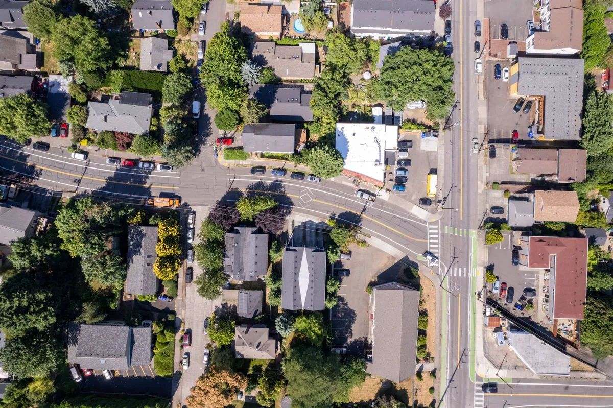 A tree-lined residential street with sidewalks, parked vehicles, and homes. The image captures the inviting, walkable nature of the neighborhood, ideal for family strolls, bike rides, and local adventures just outside the door.